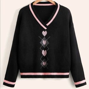 Black sweater with pink boarders and pink hearts going down the middle